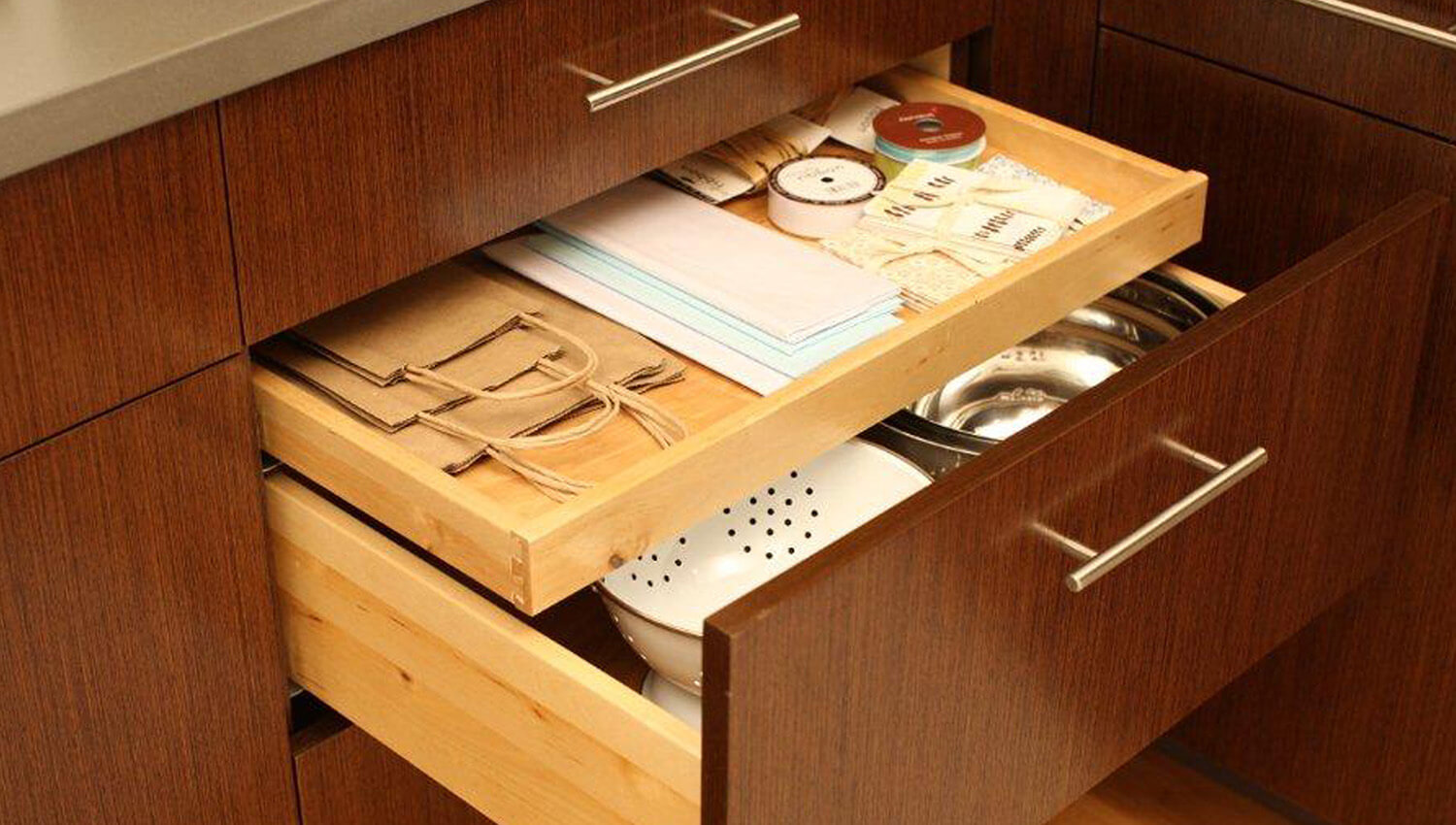 A Shallow Roll-Out Above Drawer is a great way to store miscellaneous school supplies and lunch bags. 
