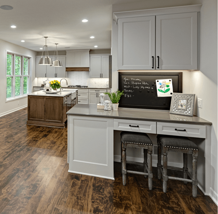 A charming Kitchen Command Center sits adjacent from a beautiful kitchen designed by Kristen Peck of Knight Construction Design. Photographed by Mark Ehlen of Ehlen Creative.