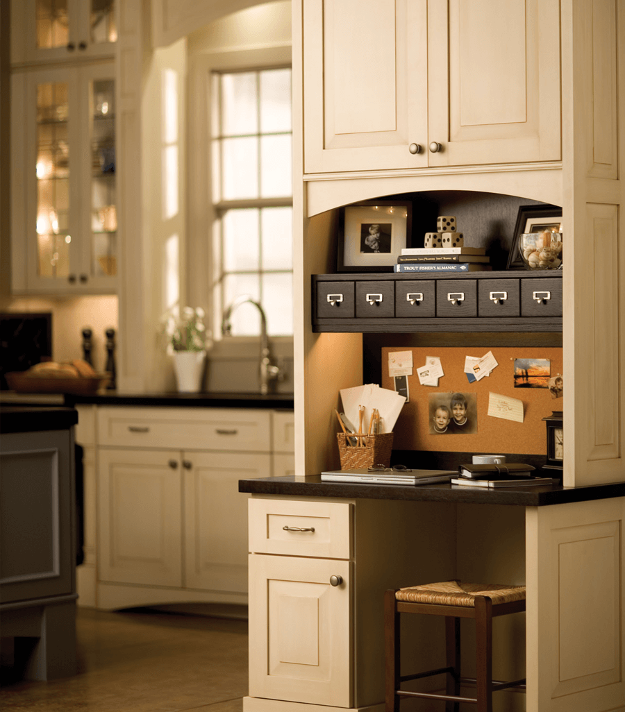 An office desk in a kitchen. Kitchen cabinets and office desk by Dura Supreme Cabinetry.