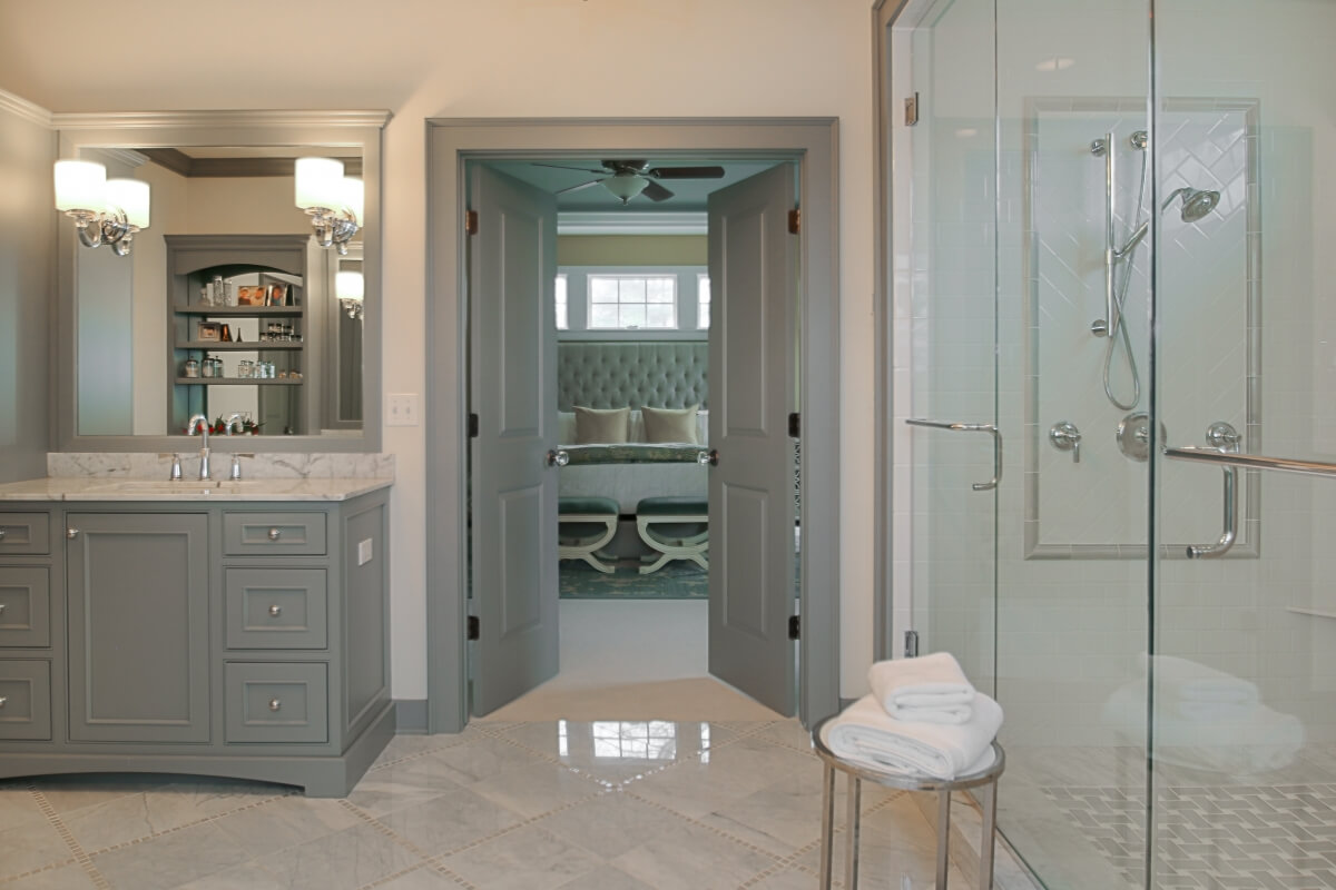This lovely bathroom design was designed by Stephanie Frees & Jennifer Riordan of Plain & Posh Distinctive Cabinet Designs, Westmont, IL. Photographed by Focus-Pocus. This design is a fantastic example of following the NKBA Door Interference Guideline since the entry door is located away from the main bath fixtures and opens out into the bedroom.