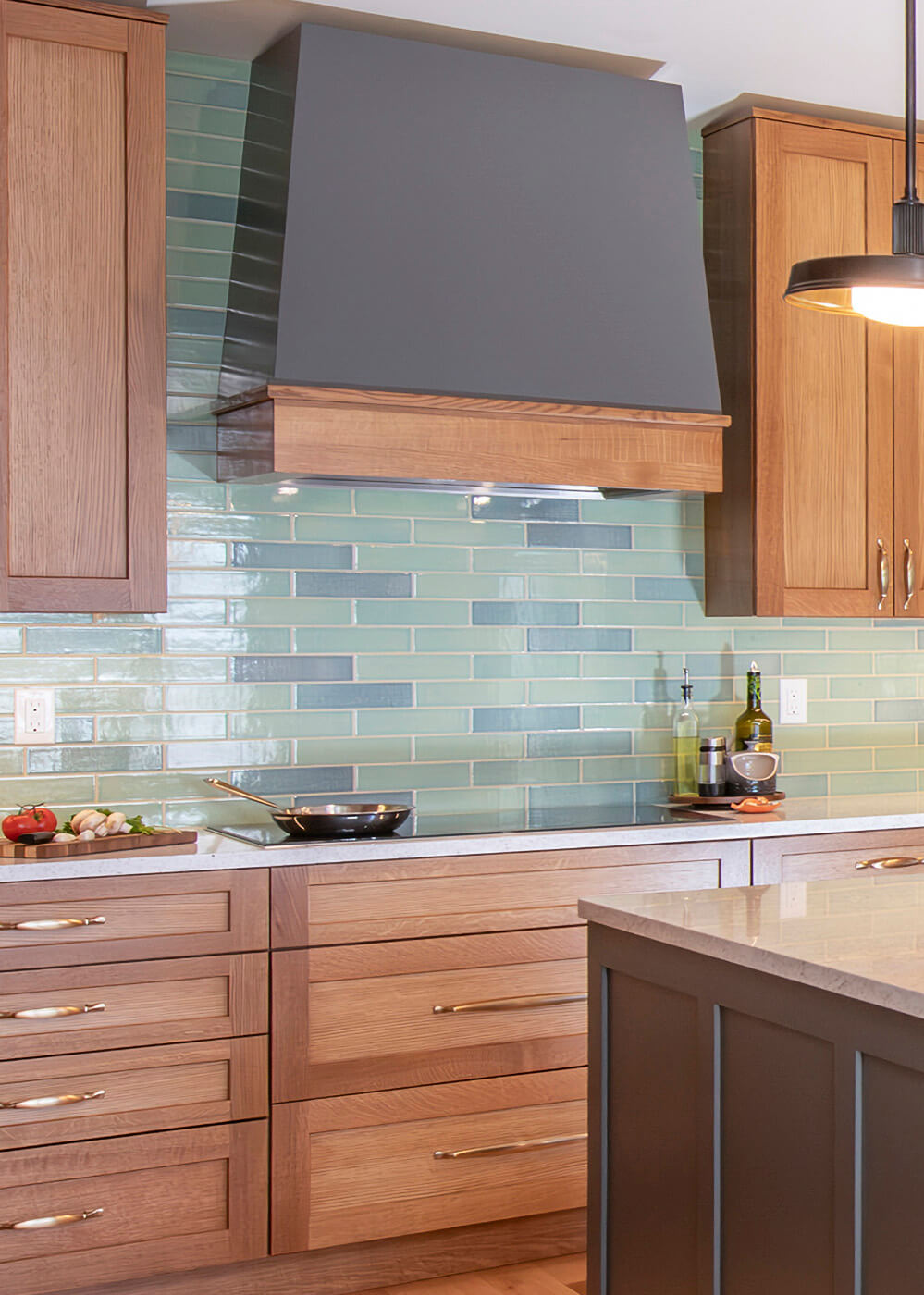 A craftsman styled kitchen with a two-toned modern wood hood.