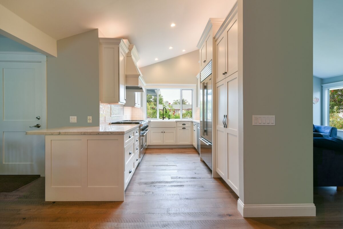 Cabinet and wall lengths can vary in size on a U-shape kitchen design. This beautiful kitchen design showcases a great example of how the U-shape design can be flexible and tailored to each space.