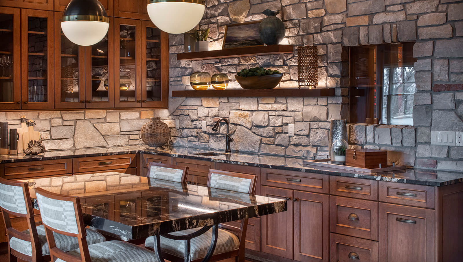 A rustic Craftsman styled wet bar design with a stone wall.