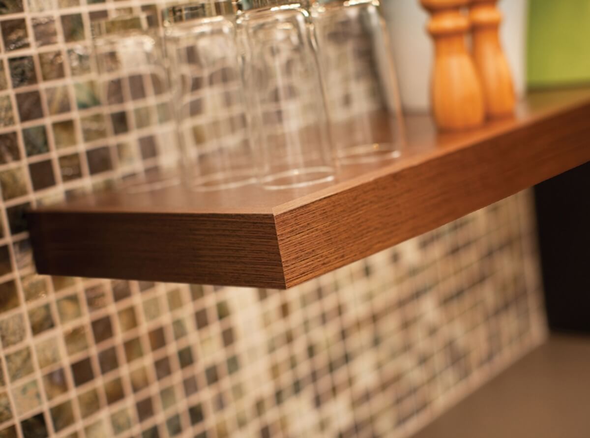 Floating shelves maintain an open, airy look which Urban Loft interior designs are known for.