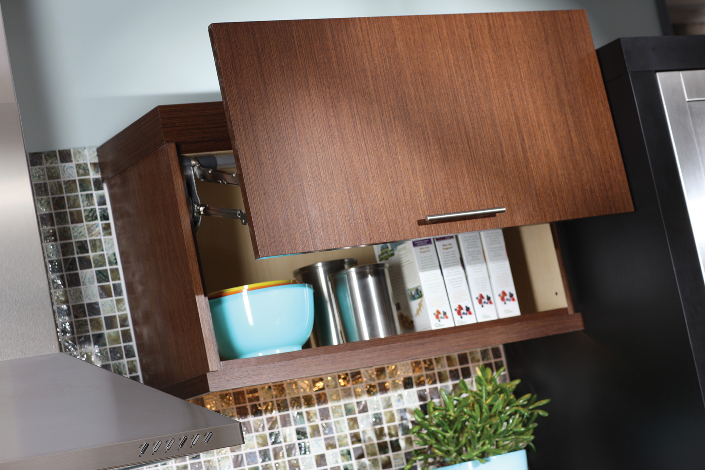 If space allows above the cabinet, a lift-door (WLD) provides full-access to upper cabinets that are hard to reach. Kitchen storage idea from Dura Supreme Cabinetry.