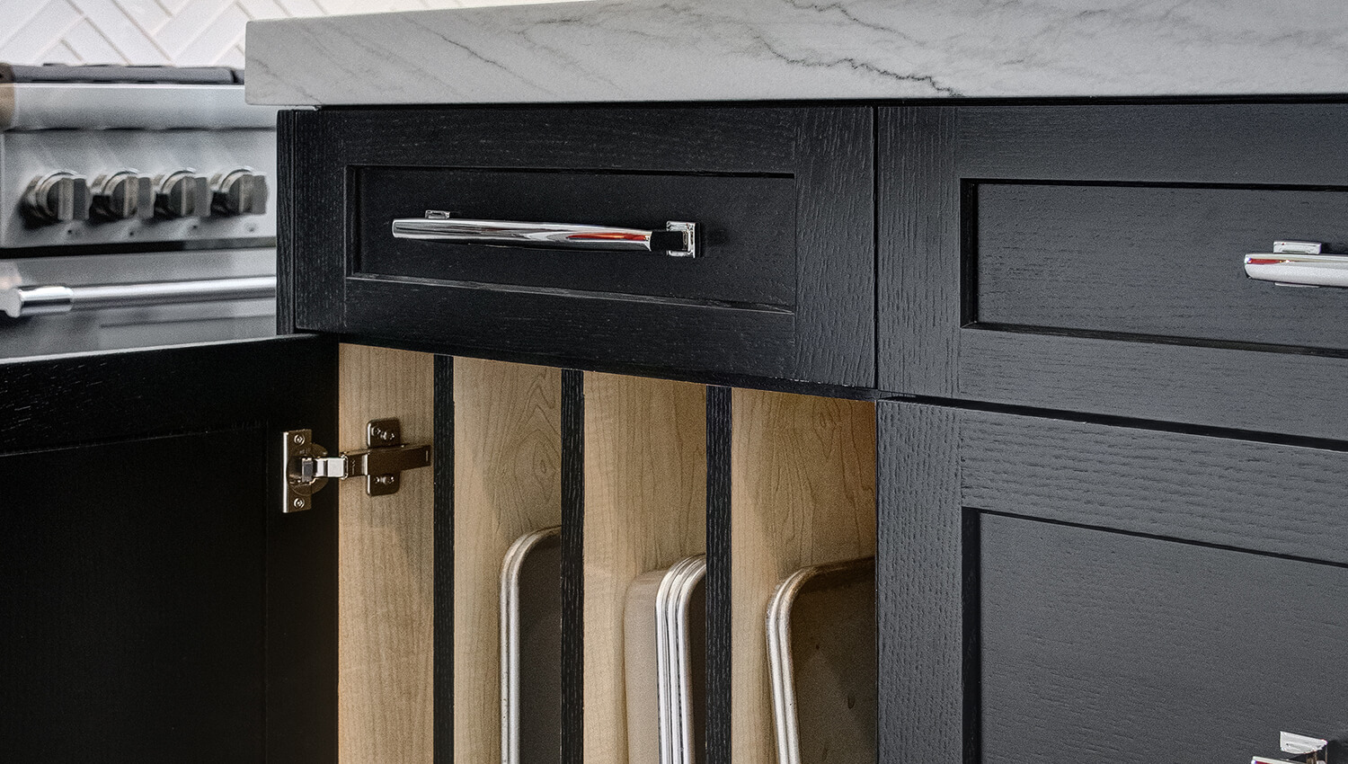 A close up of black painted oak cabinets.