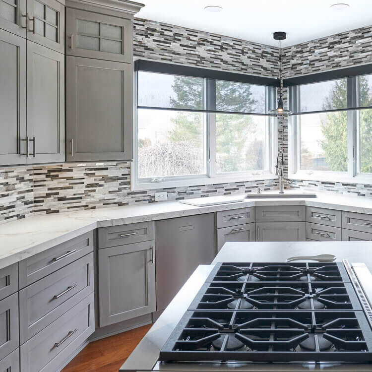 An all gray kitchen with a casual modern design and shaker style cabinets.