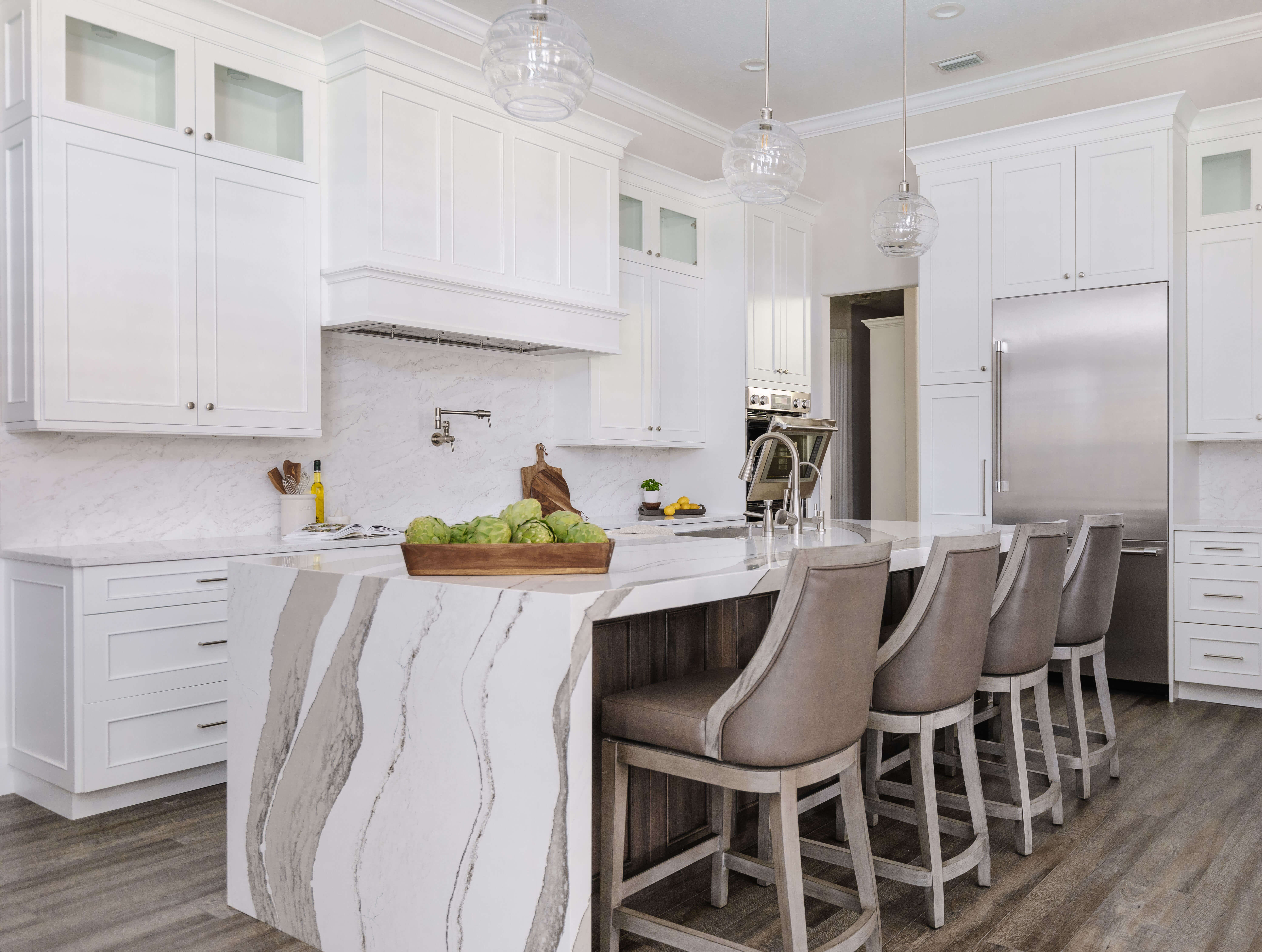 Before and after kitchen remodel. This is after the remodel showing the new kitchen island, kitchen cabinets, and wood hood.