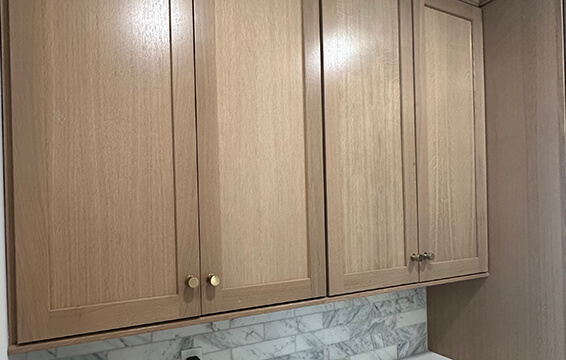 A close up of shaker cabinets with a stained finish from Dura Supreme Cabinetry.