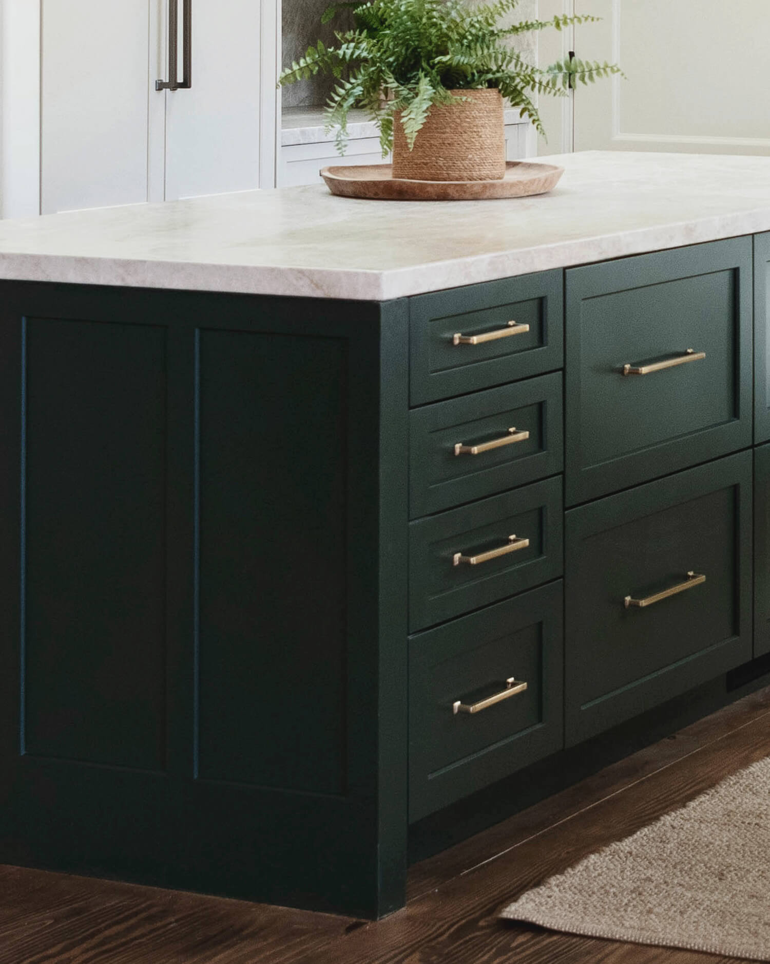 A trendy dark green painted kitchen island by Dura Supreme Cabinetry.