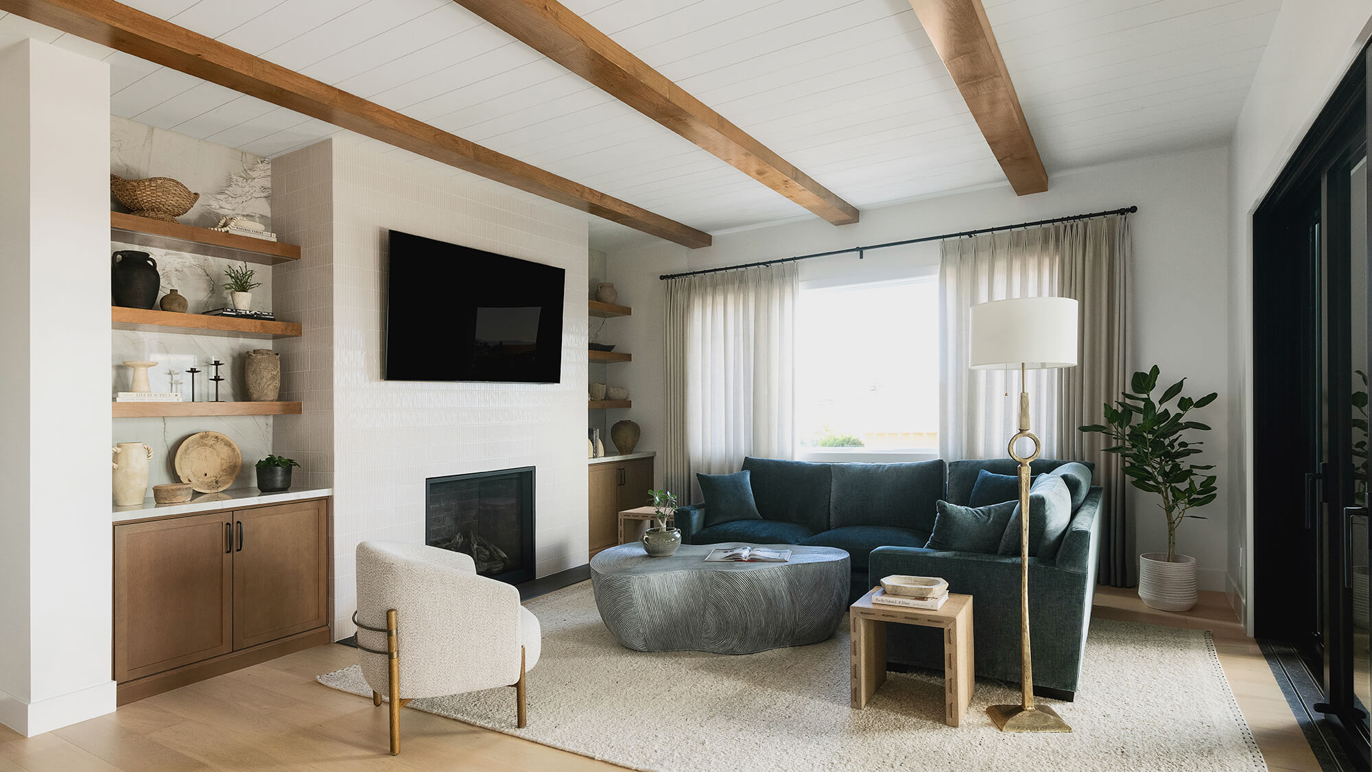 A luxury home with custom built-in cabinets surrounding the fireplace with medium stained cabinets featuring a trendy shaker door style.