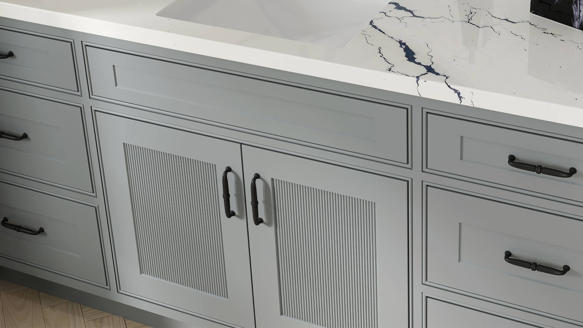 A gray painted vanity with reeded cabinets.