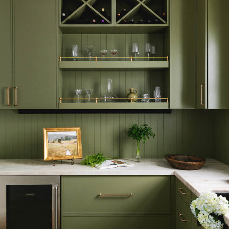 A great example of the interior design trend of Color Drenching in an all olive green walk-in pantry.