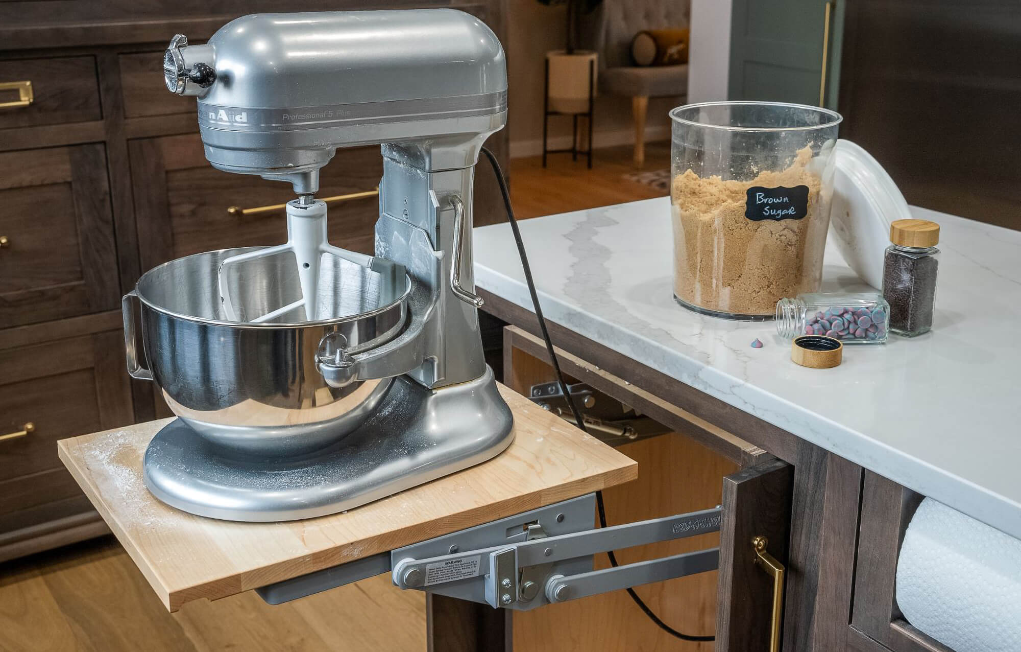 A lift-up mixer shelf on a kitchen island designed to be the ultimate baking zone.