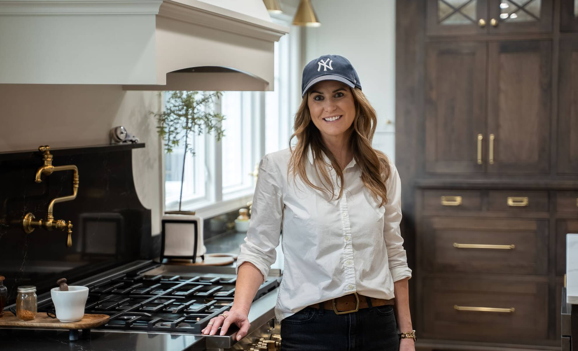 Homeowner Amy U. is in her new kitchen, which LS Building Products designed with Dura Supreme Cabinetry.