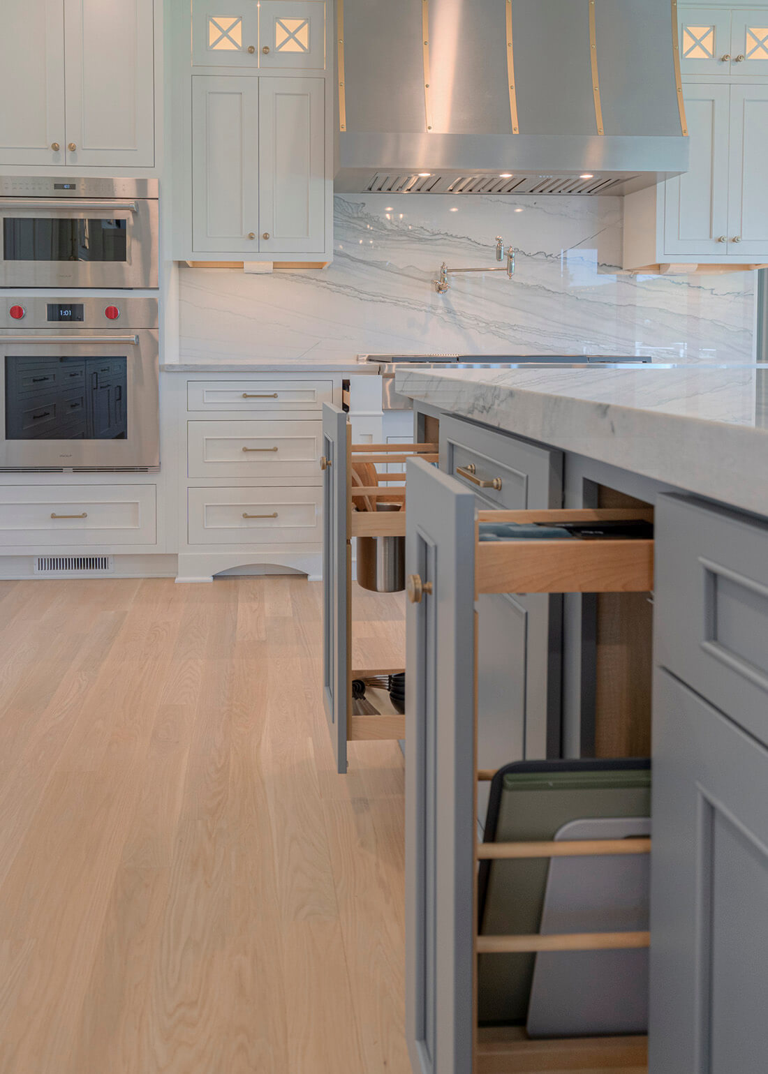 A Pull-Out Tray Cabinet from Dura Supreme offers practical and convenient use of space and works great for storing pans and cookie sheets in small spaces.