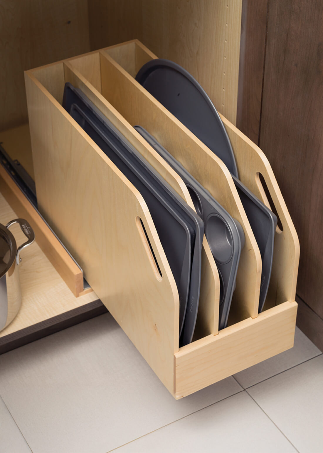A Pull-Out Tray Cabinet from Dura Supreme offers practical and convenient use of space and works great for storing pans and cookie sheets in small spaces.
