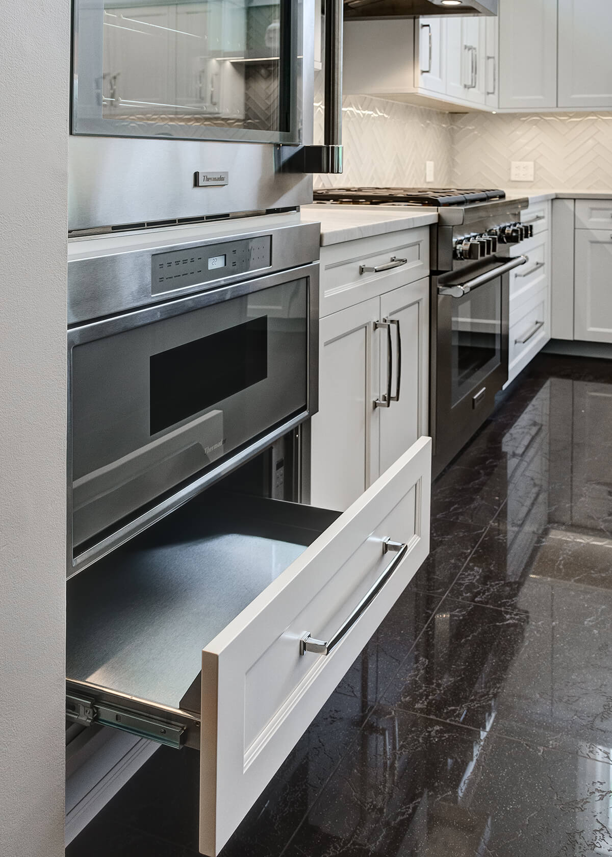 A hidden warming drawer behind a Dura Supreme drawer front, ready to keep pies, tarts, and bread warm.