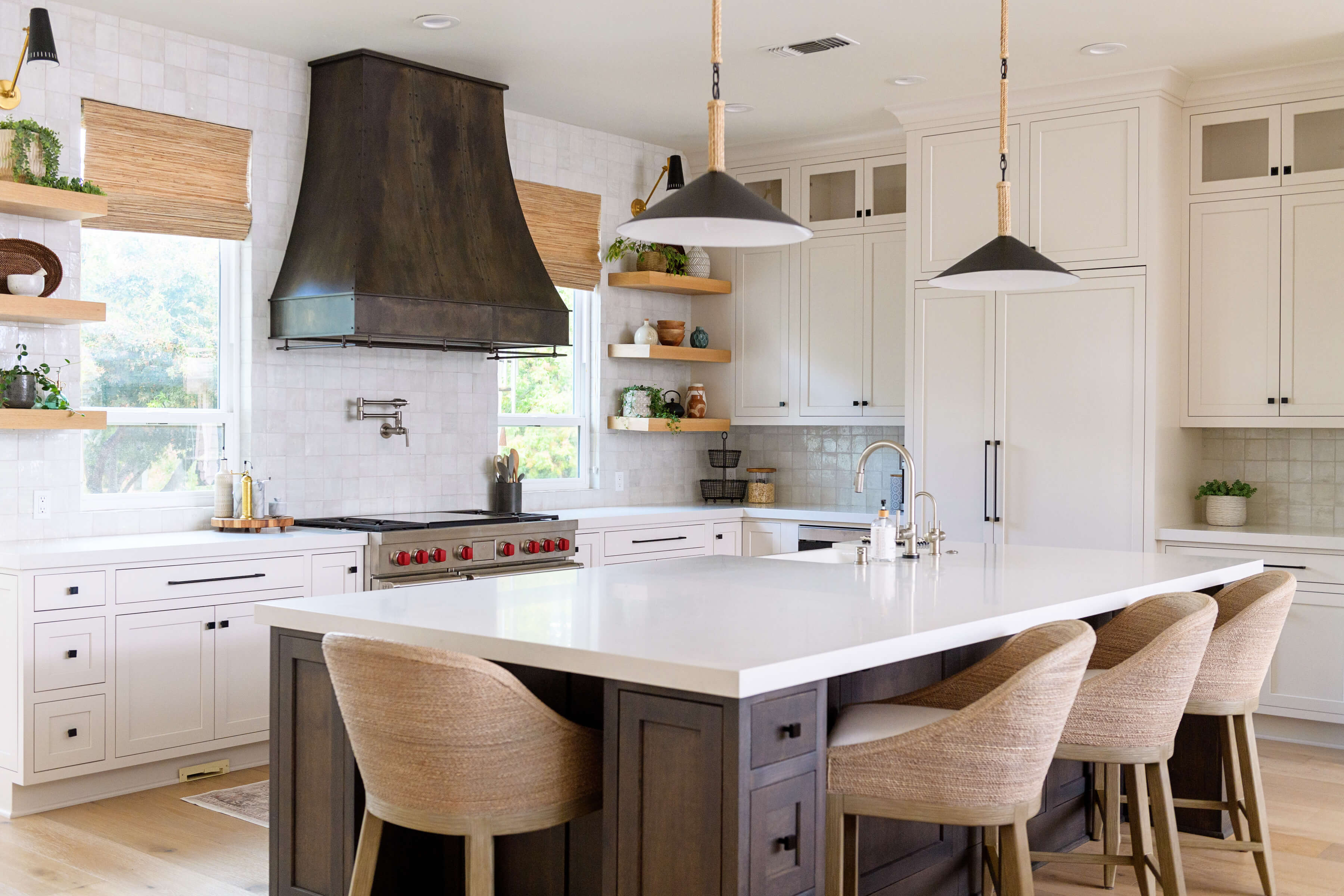A transitional styled modern farmhouse kitchen with simplistic shaker cabinet doors with inset construction. This two-tone kitchen features white paint for the perimeter and a dark stain for the kitchen island.